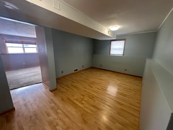a view of a kitchen with a sink and stainless steel appliances