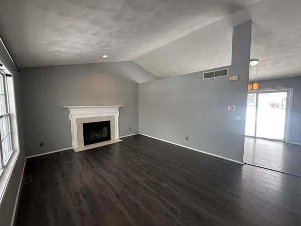 a kitchen with stainless steel appliances granite countertop a refrigerator a stove top oven a sink and dishwasher