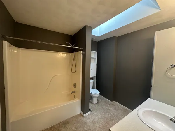 a bathroom with a toilet a sink and shower