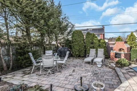 a view of a chairs and table in backyard