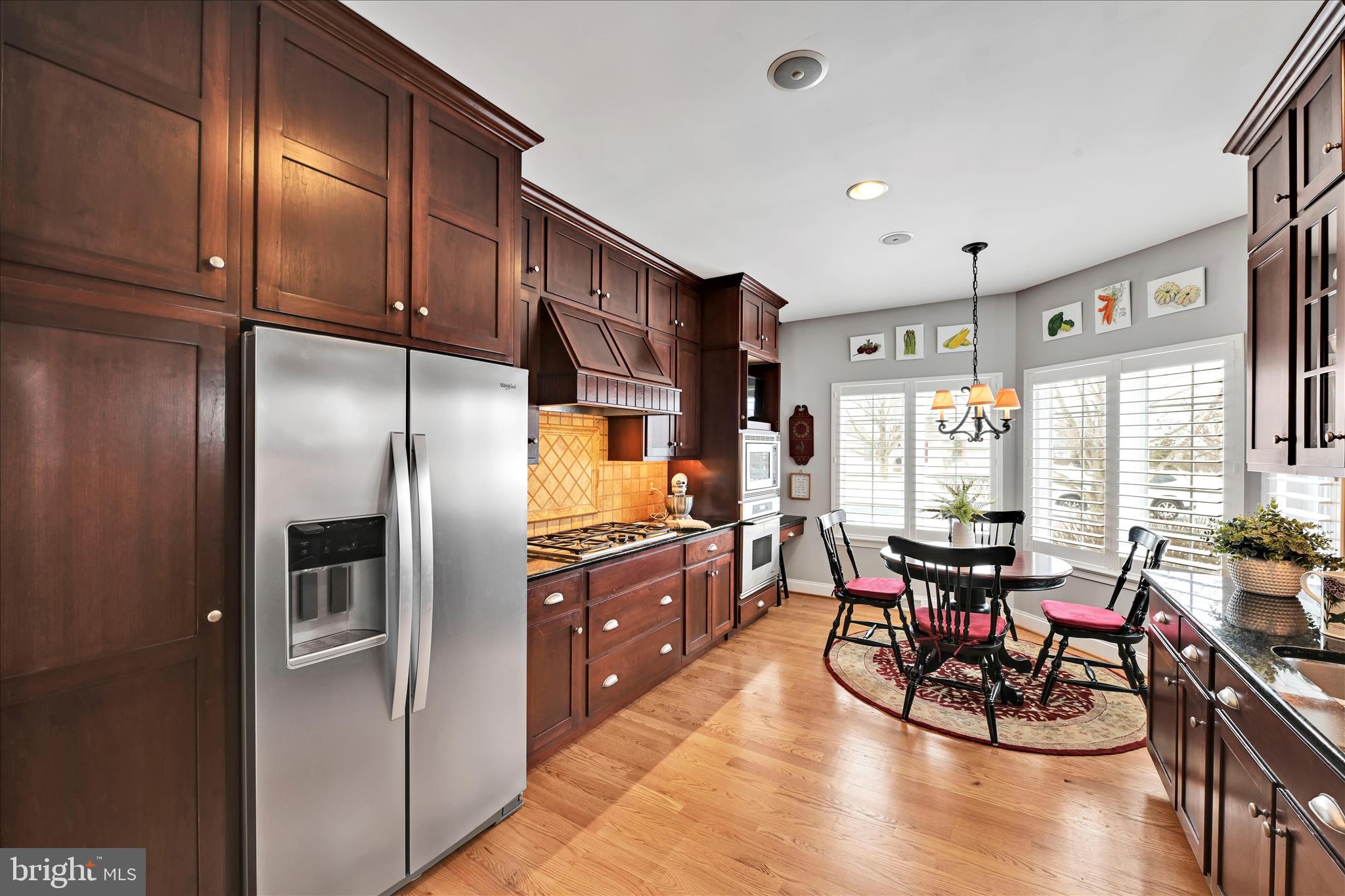 728 Woodfield Drive Lititz, PA 17543 - Photo 16 of 61 a kitchen with granite countertop a refrigerator cabinets dining table and chairs