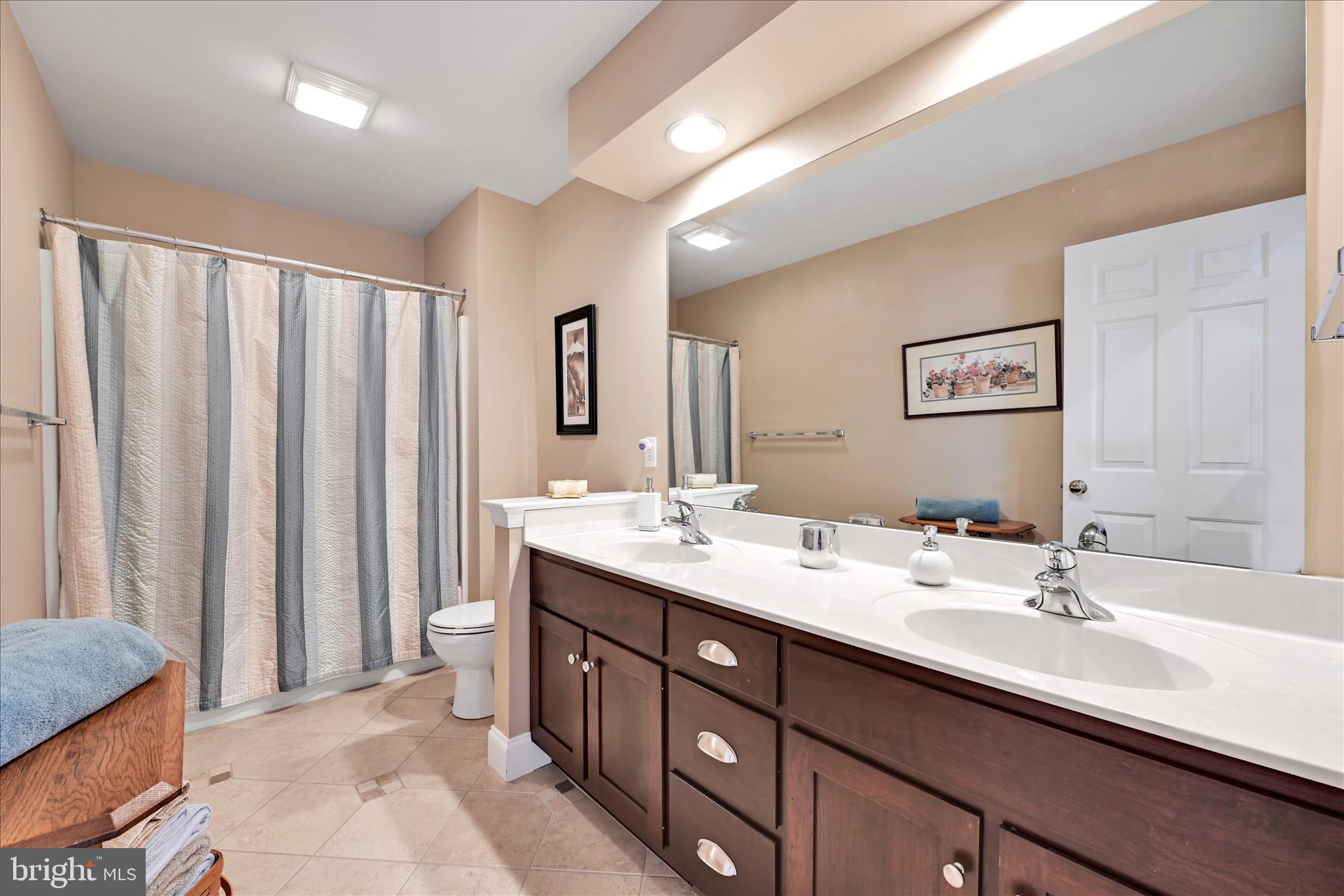 728 Woodfield Drive Lititz, PA 17543 - Photo 28 of 61 a bathroom with a double vanity sink and a mirror