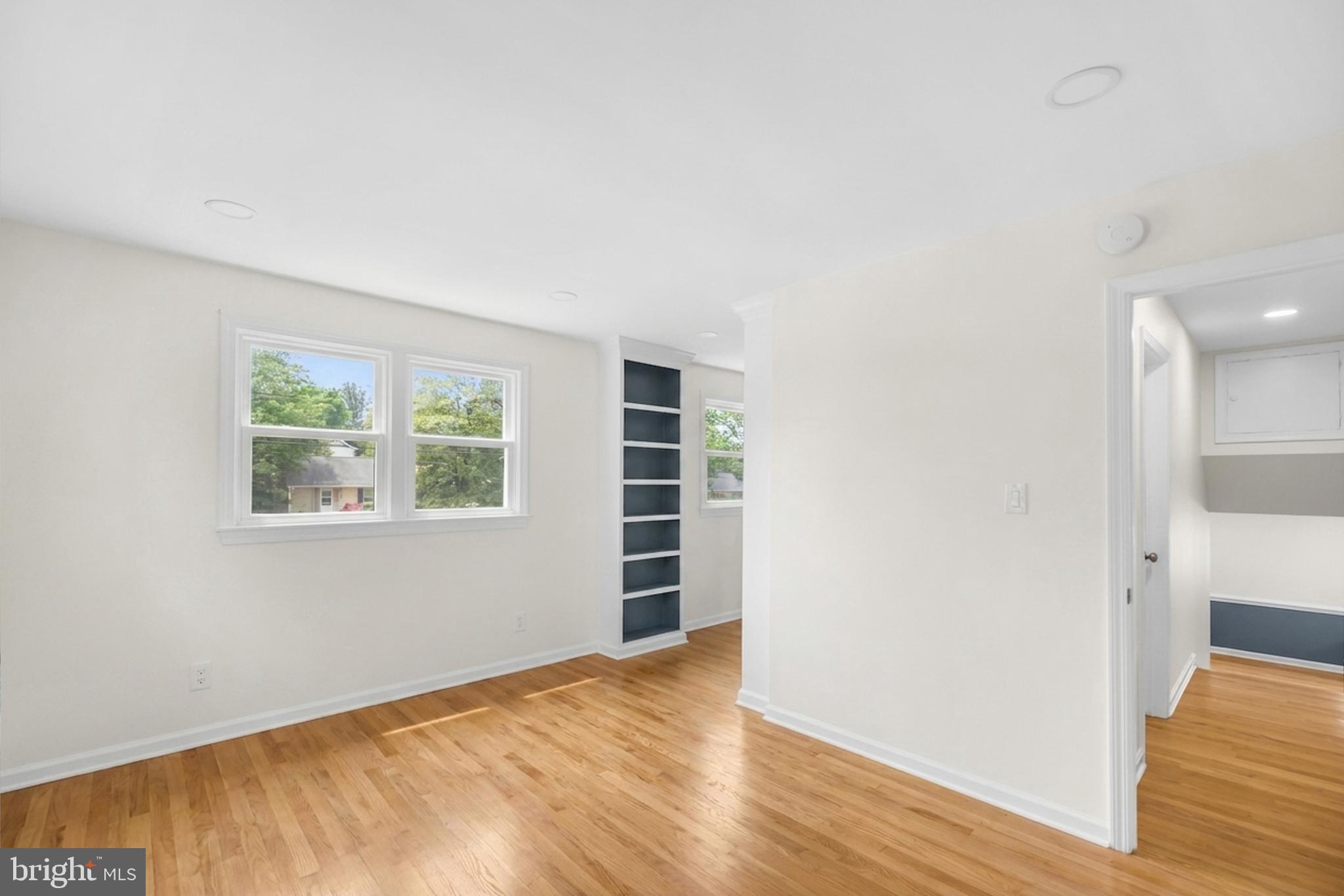 7402 Dunston Street Springfield, VA 22151 - Photo 24 of 37 an empty room with wooden floor and windows