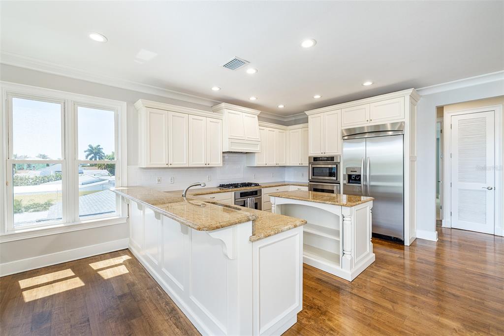 821 Bay Point Drive Madeira Beach, FL 33708 - Photo 12 of 66 a kitchen with a stove a sink and a refrigerator