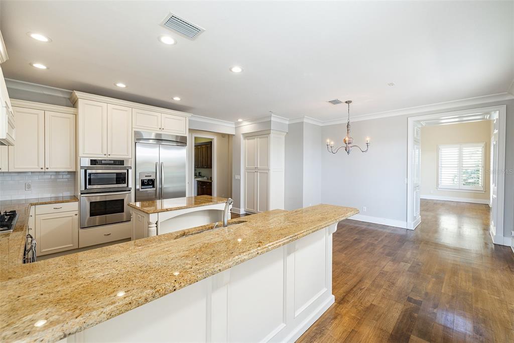 821 Bay Point Drive Madeira Beach, FL 33708 - Photo 13 of 66 a large kitchen with kitchen island a sink stainless steel appliances and cabinets