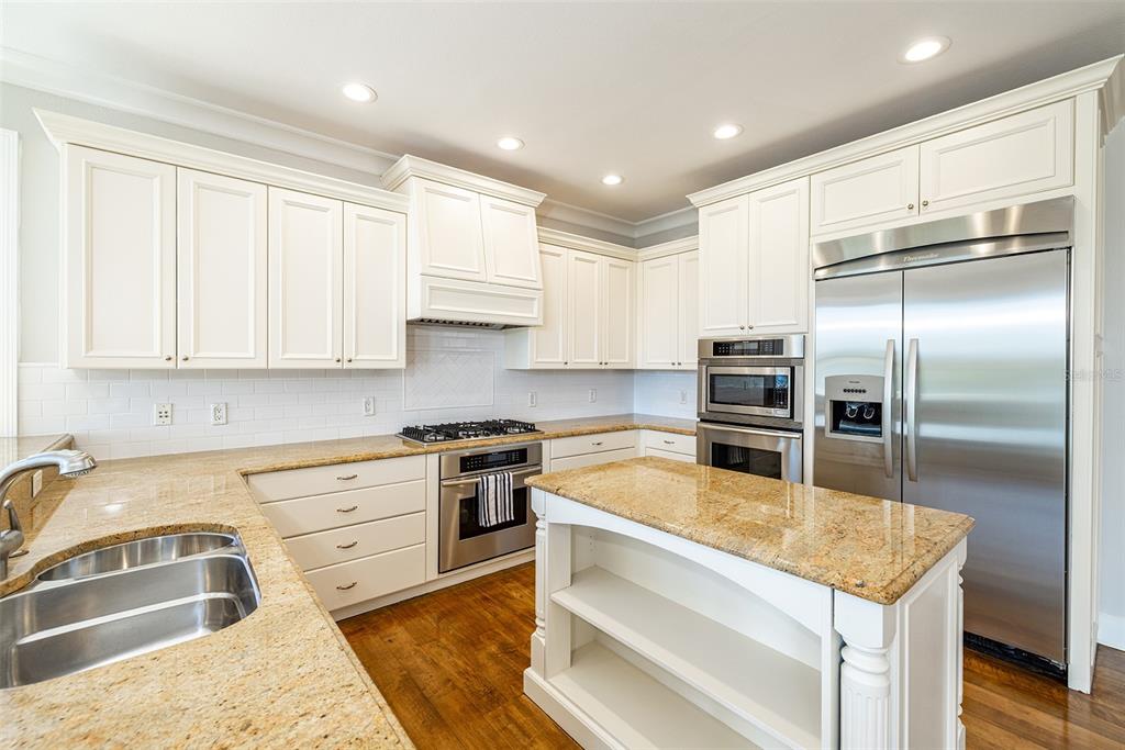 821 Bay Point Drive Madeira Beach, FL 33708 - Photo 14 of 66 a kitchen with a refrigerator sink and cabinets