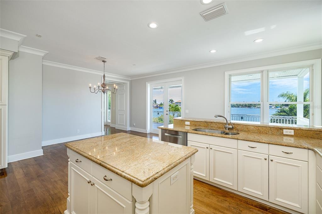 821 Bay Point Drive Madeira Beach, FL 33708 - Photo 15 of 66 a kitchen with a sink stove and cabinets