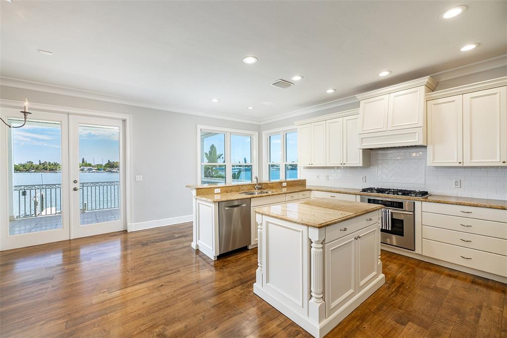 821 Bay Point Drive Madeira Beach, FL 33708 - Photo 16 of 66 a kitchen with a stove a sink and a refrigerator