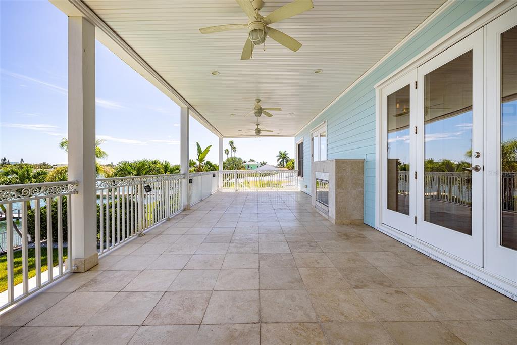 821 Bay Point Drive Madeira Beach, FL 33708 - Photo 17 of 66 a view of a porch with a table and chairs