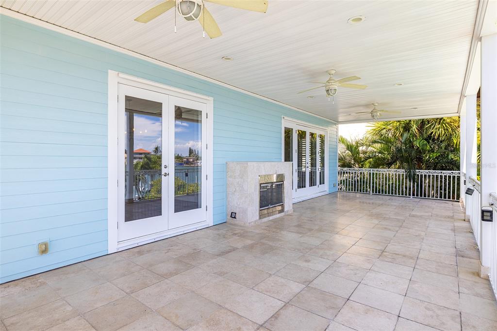 821 Bay Point Drive Madeira Beach, FL 33708 - Photo 18 of 66 a view of a porch with furniture and floor to ceiling window