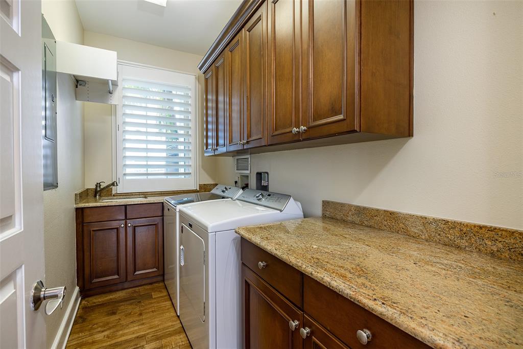 821 Bay Point Drive Madeira Beach, FL 33708 - Photo 24 of 66 a utility room with a sink washer and dryer