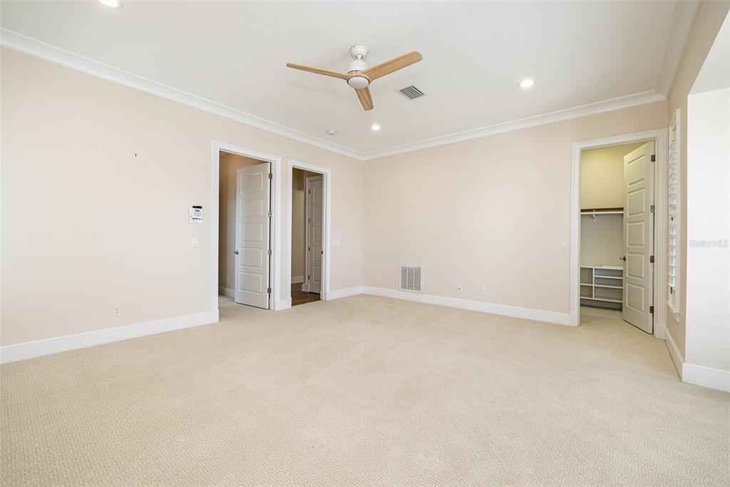 821 Bay Point Drive Madeira Beach, FL 33708 - Photo 31 of 66 an empty room with closet and a ceiling fan