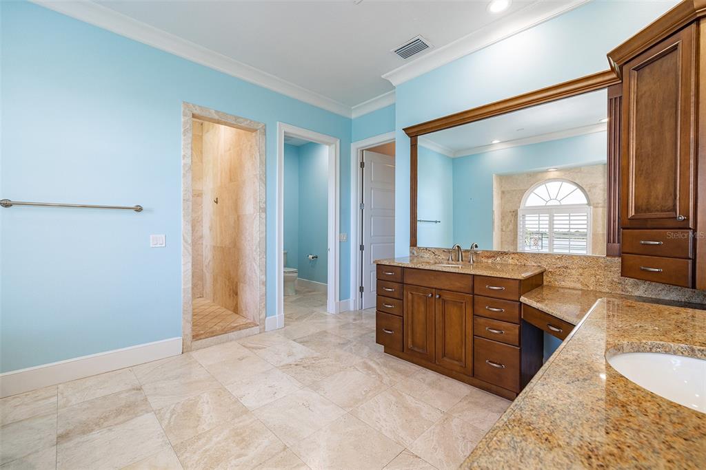 821 Bay Point Drive Madeira Beach, FL 33708 - Photo 35 of 66 a large bathroom with a granite countertop tub sink and mirror