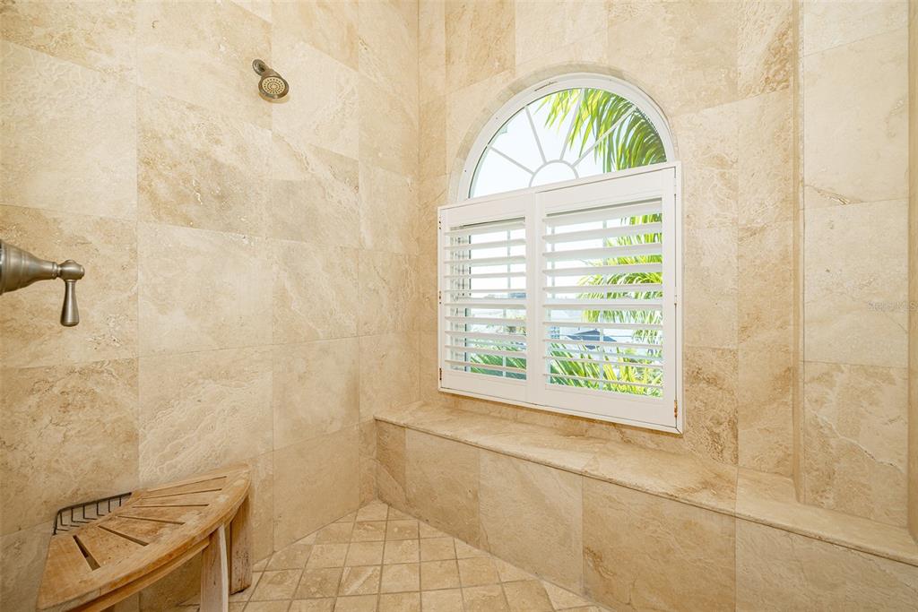 821 Bay Point Drive Madeira Beach, FL 33708 - Photo 37 of 66 a bathroom with a window a bathtub and a shower