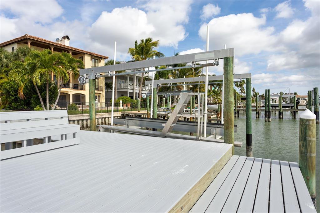 821 Bay Point Drive Madeira Beach, FL 33708 - Photo 45 of 66 a view of a patio with lawn chairs wooden floor and city view