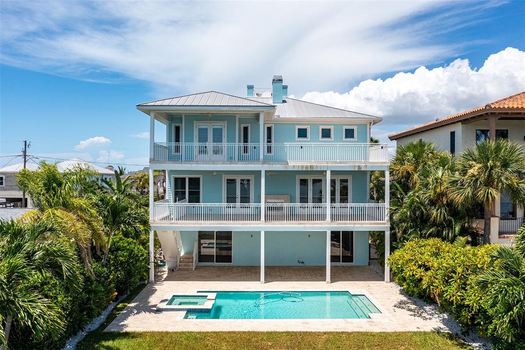 821 Bay Point Drive Madeira Beach, FL 33708 - Photo 55 of 66 a view of a house with a yard and potted plants
