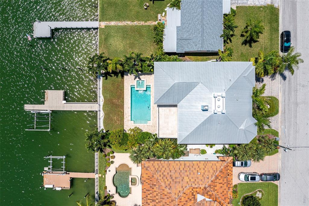 821 Bay Point Drive Madeira Beach, FL 33708 - Photo 57 of 66 an aerial view of a house with yard swimming pool and outdoor seating