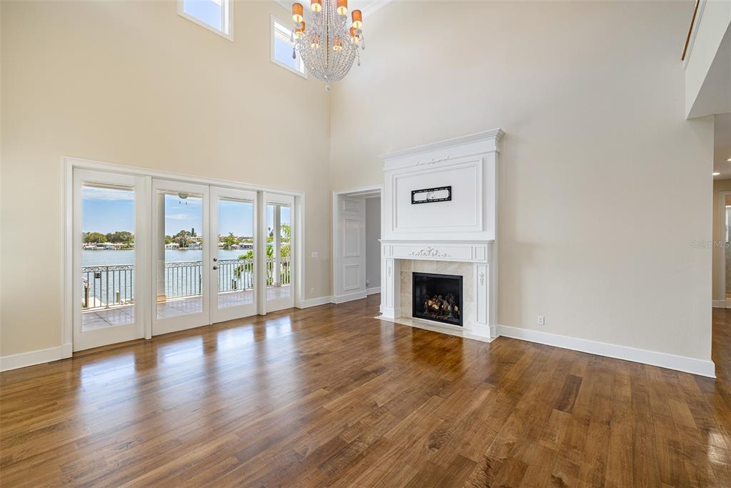 821 Bay Point Drive Madeira Beach, FL 33708 - Photo 6 of 66 a view of an empty room with wooden floor and a window