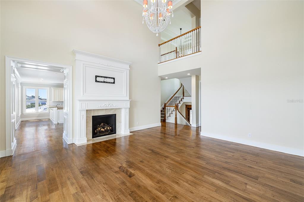 821 Bay Point Drive Madeira Beach, FL 33708 - Photo 7 of 66 a view of a livingroom with wooden floor a fireplace and windows