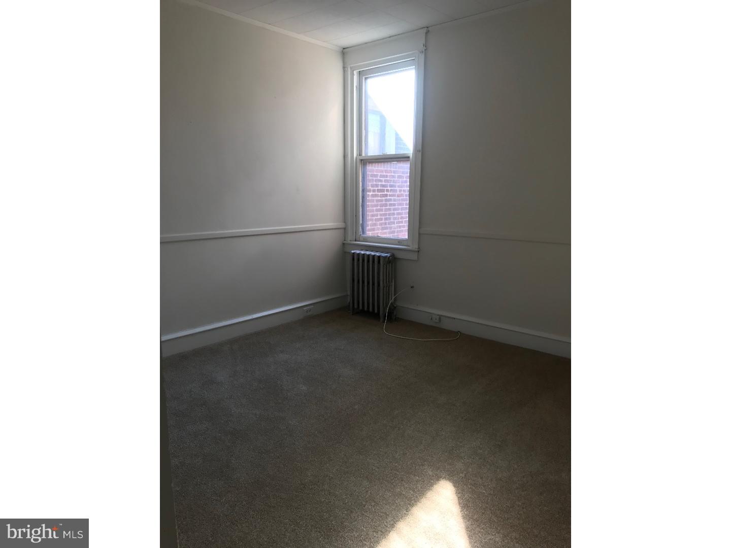 212 Wembly Road Upper Darby, PA 19082 - Photo 11 of 12 a view of an empty room with a window