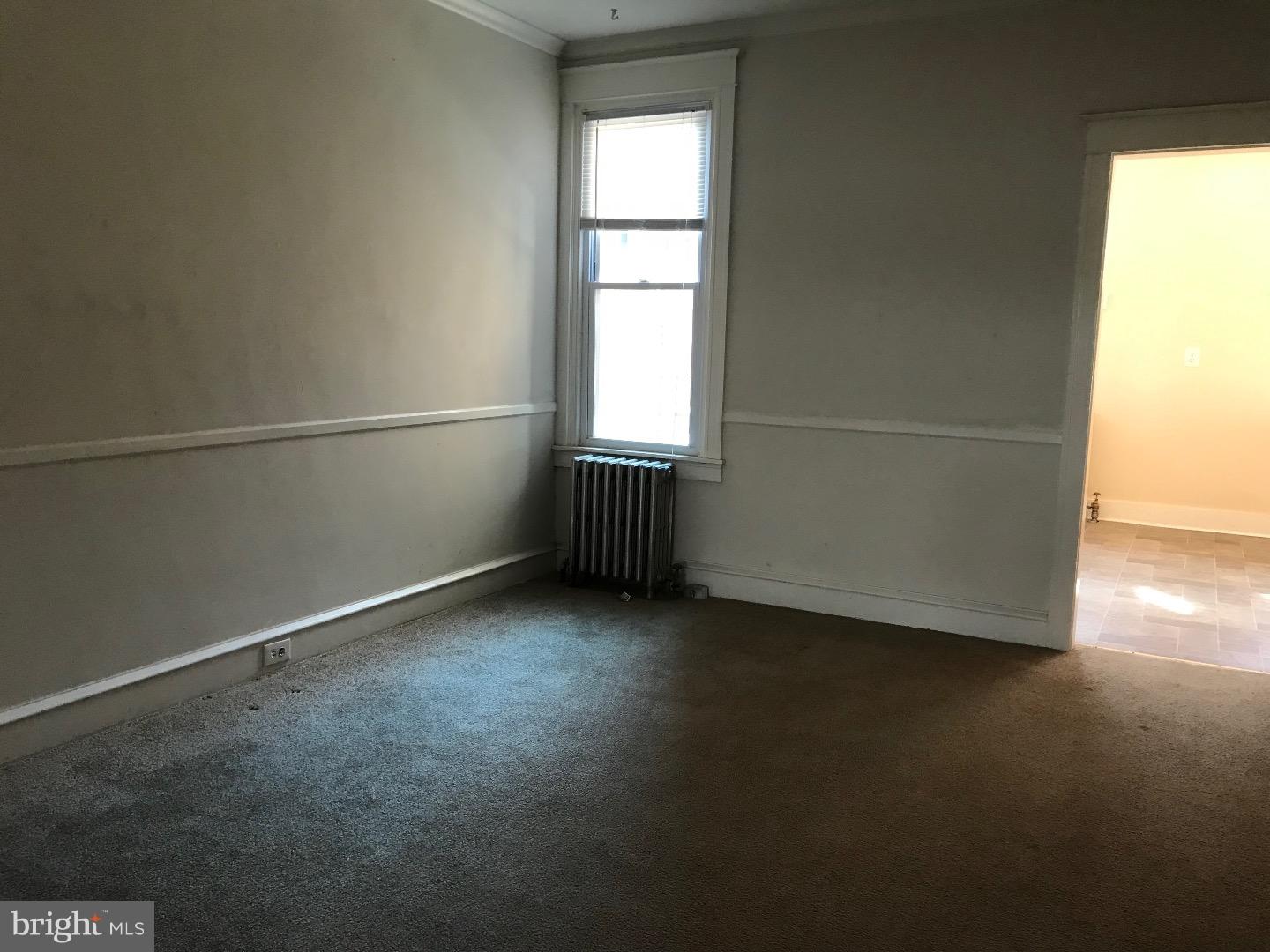 212 Wembly Road Upper Darby, PA 19082 - Photo 4 of 12 an empty room with wooden floor and windows