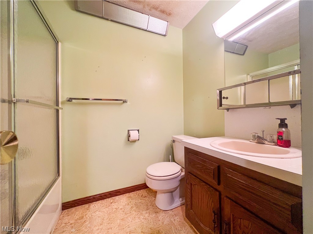 1431 May Road Mogadore, OH 44260 - Photo 8 of 22 Full bathroom with combined bath / shower with glass door, large vanity, a skylight, mirror, and light tile floors