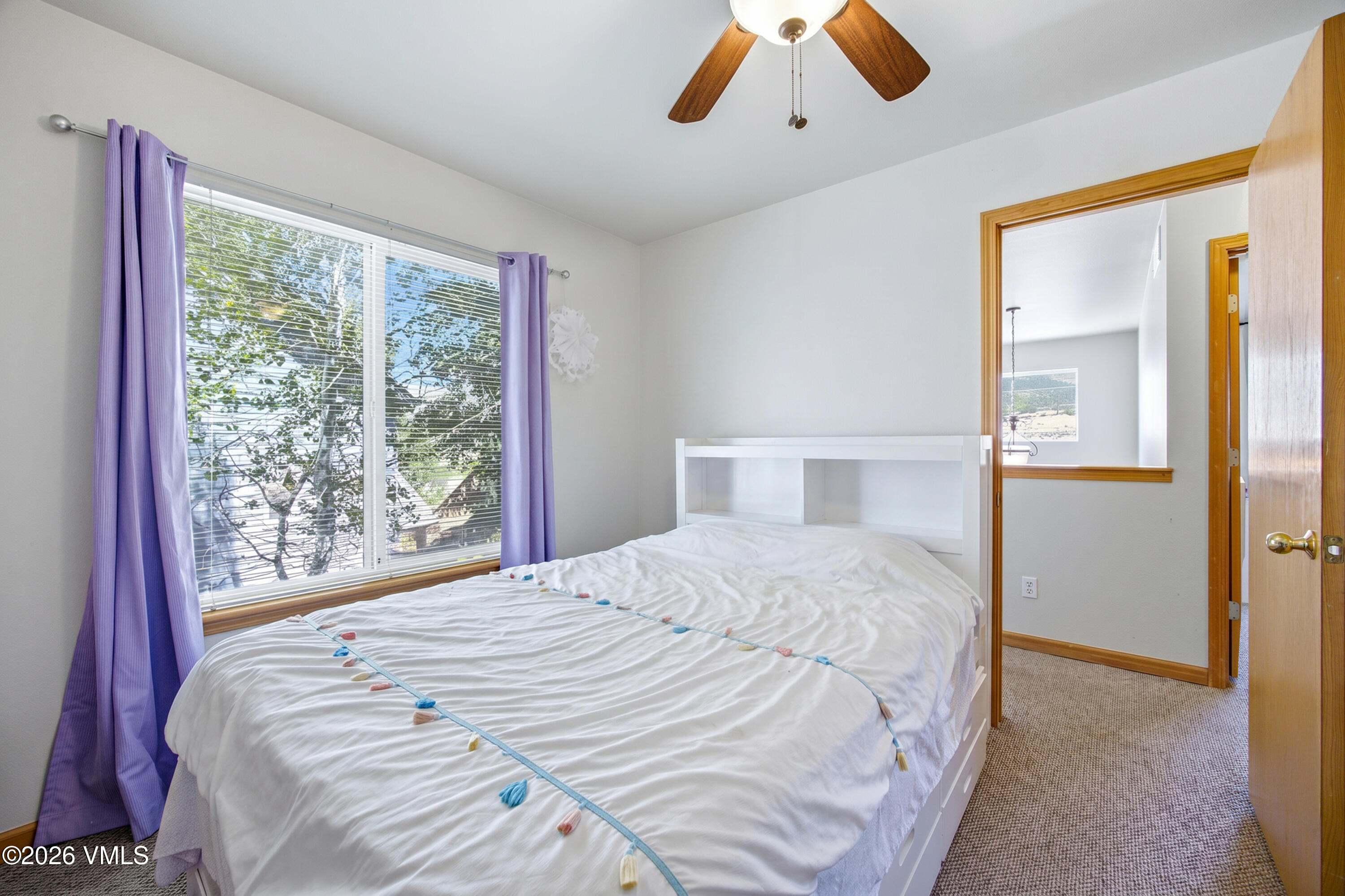 107 Stonegate Circle Edwards, CO 81632 - Photo 11 of 26 a bedroom with a bed and a large window
