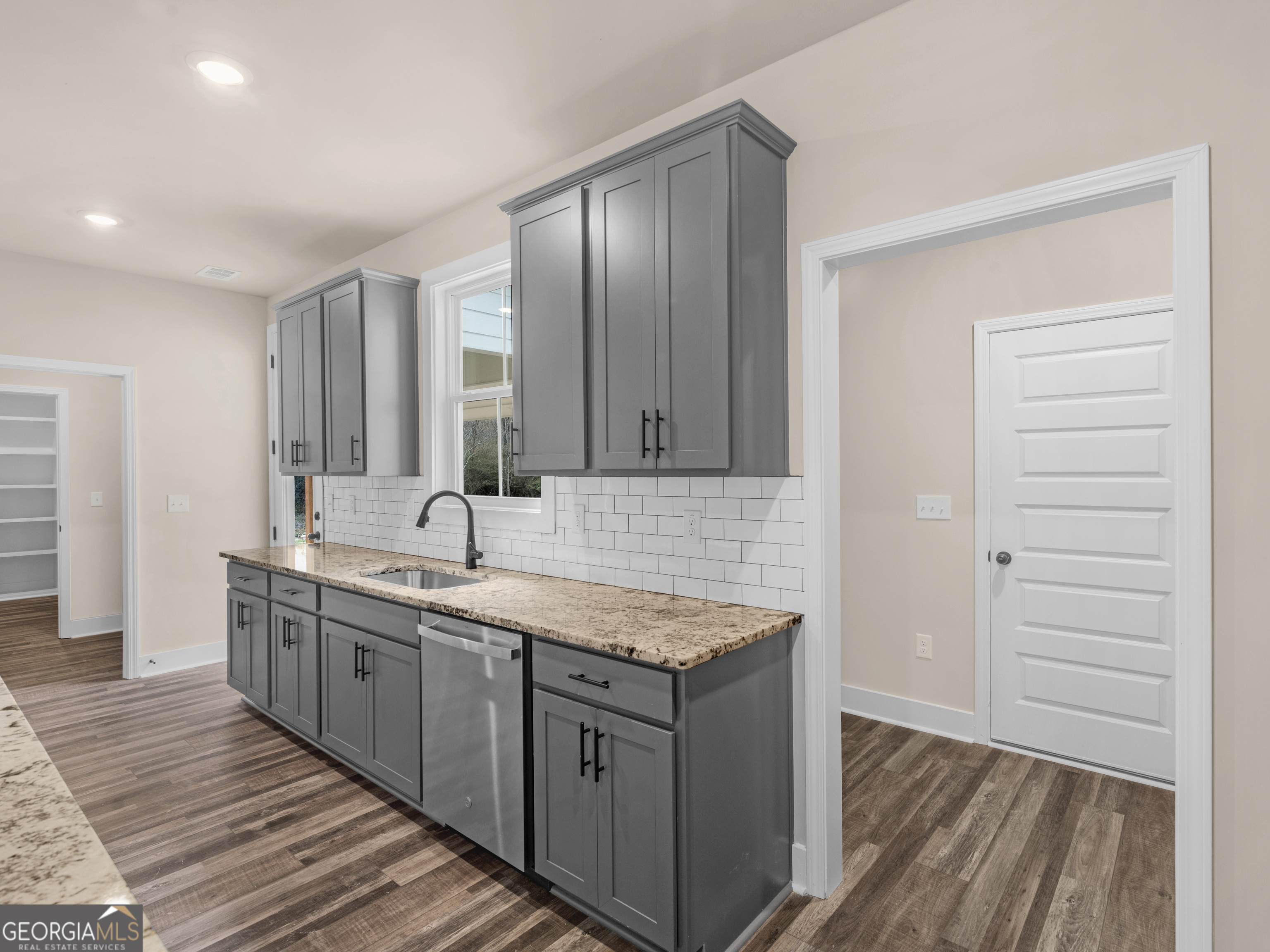 160 Loyd Road Mansfield, GA 30056 - Photo 25 of 53 a kitchen with a sink and wooden cabinets