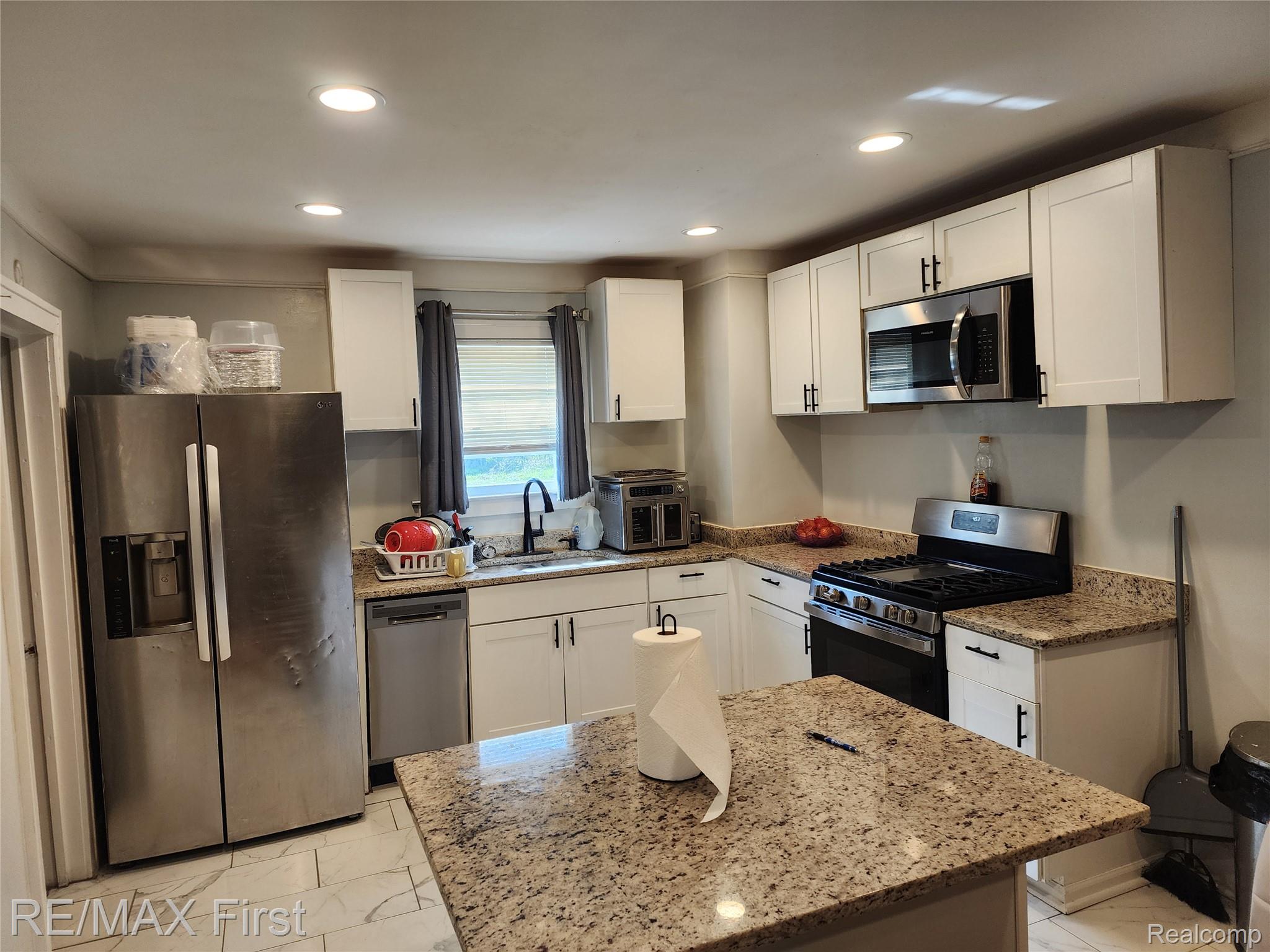 19345 Keystone Street Detroit, MI 48234 - Photo 3 of 15 Kitchen with stainless steel appliances, white cabinetry, light stone countertops, and recessed lighting