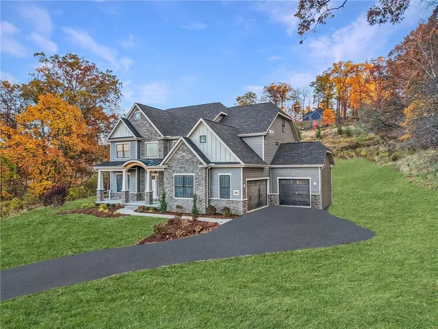 a front view of a house with a garden