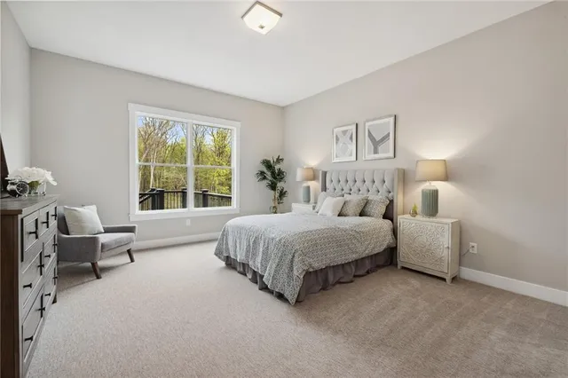 a bedroom with bed couch and window