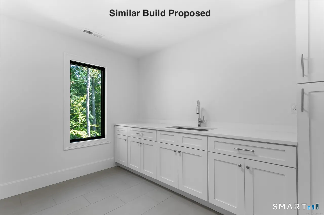110 Porters Hill Road Trumbull, CT 06611 - Photo 14 of 21 a view of a kitchen with white cabinets and a window