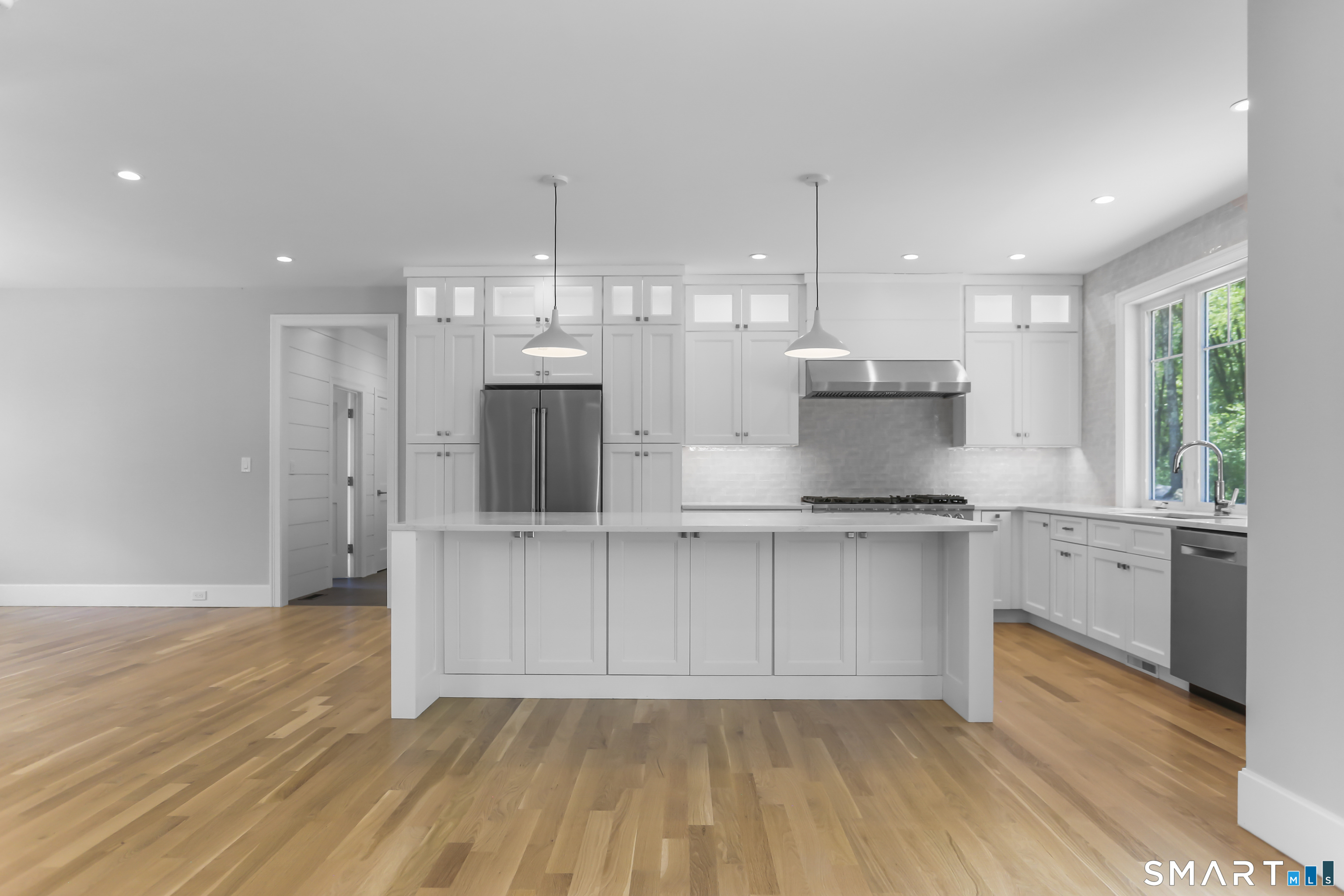 110 Porters Hill Road Trumbull, CT 06611 - Photo 15 of 47 a kitchen with stainless steel appliances granite countertop a sink a stove a refrigerator and island with wooden floor