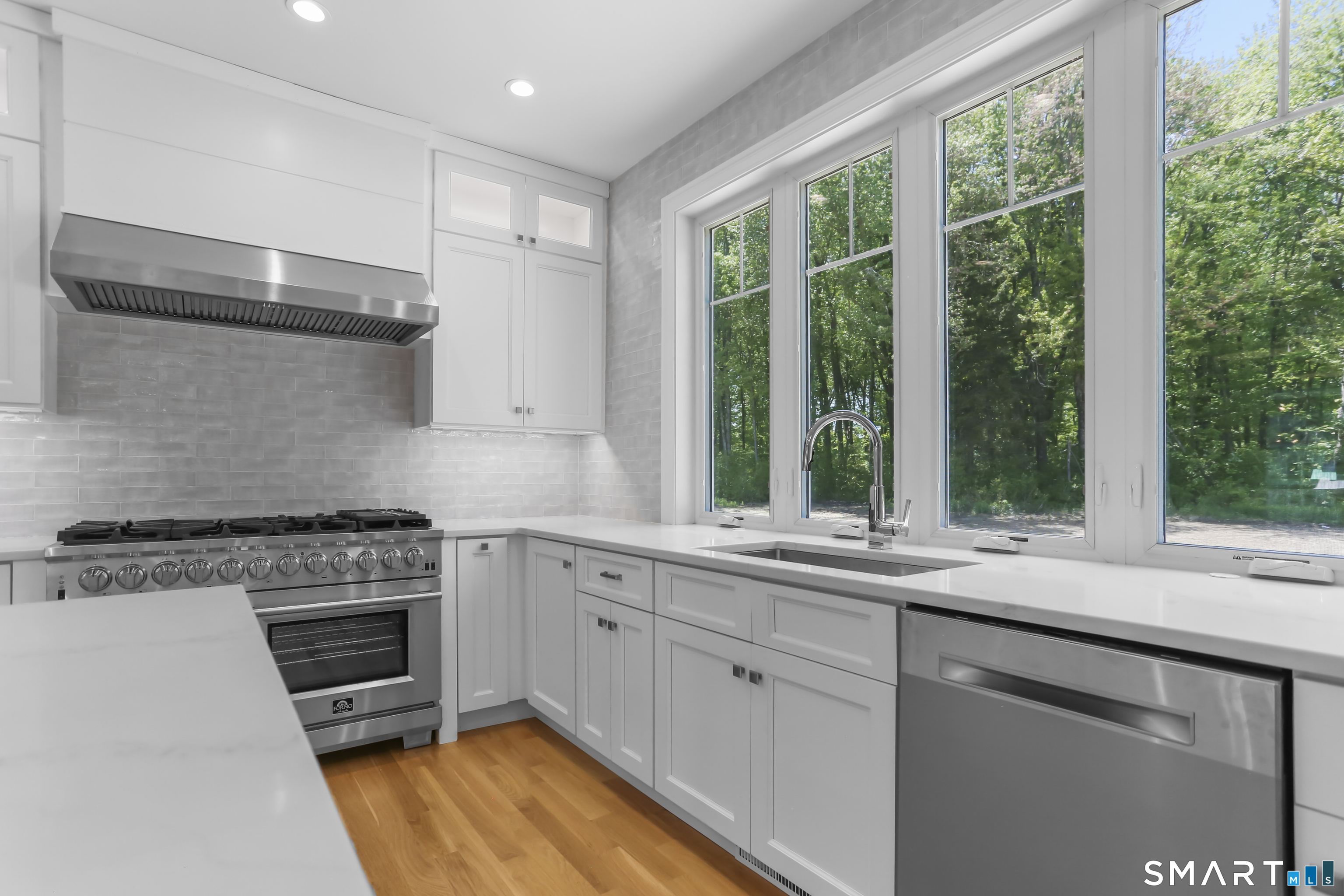 110 Porters Hill Road Trumbull, CT 06611 - Photo 16 of 47 a kitchen with a stove a sink and a wooden cabinets