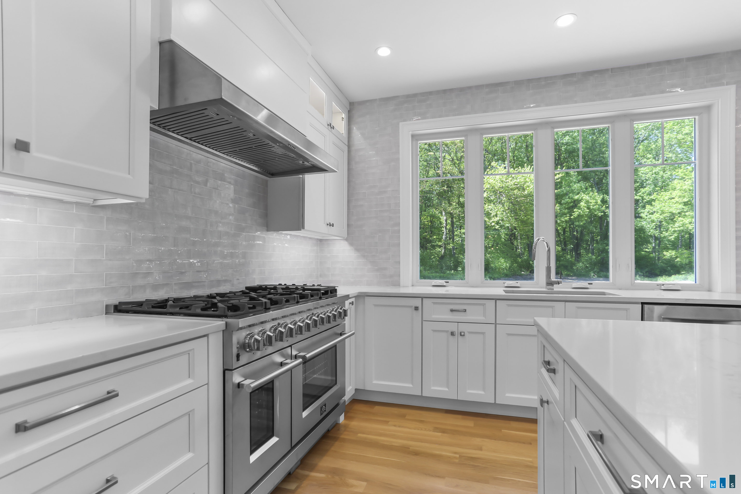 110 Porters Hill Road Trumbull, CT 06611 - Photo 18 of 47 a kitchen with stainless steel appliances granite countertop white cabinets and a window