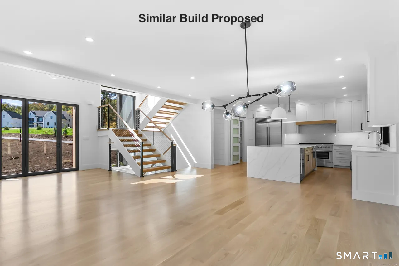 110 Porters Hill Road Trumbull, CT 06611 - Photo 29 of 47 a kitchen with stainless steel appliances kitchen island granite countertop a stove a sink a refrigerator and white cabinets with wooden floor