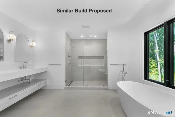 a bathroom with a bathtub a mirror a sinks and a shower
