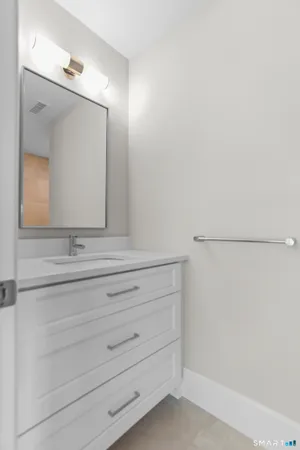 a bathroom with a sink vanity and mirror