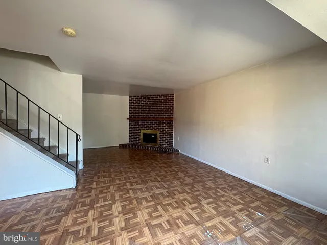a view of empty room with a fireplace