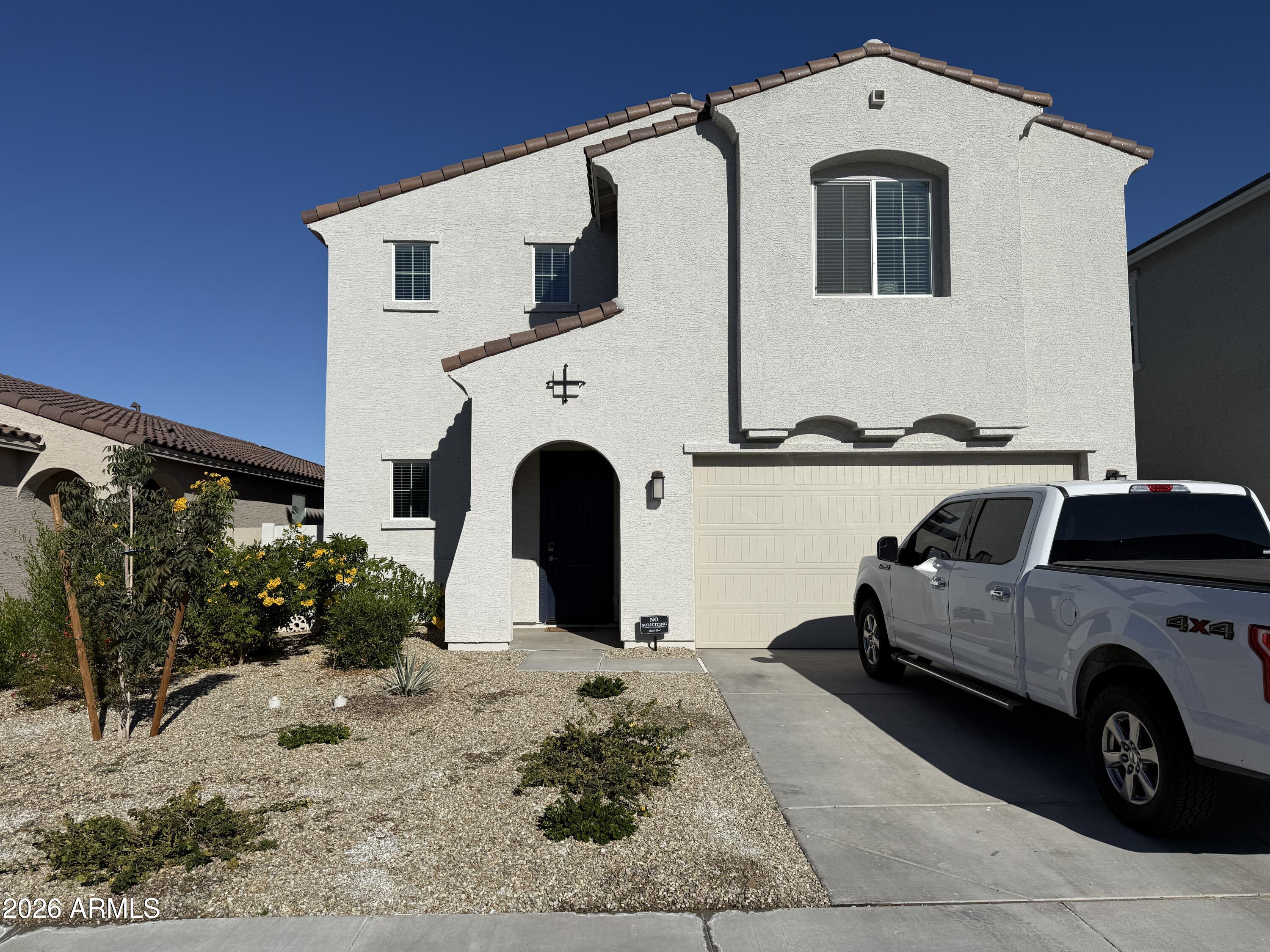 a view of a car park in front of a house