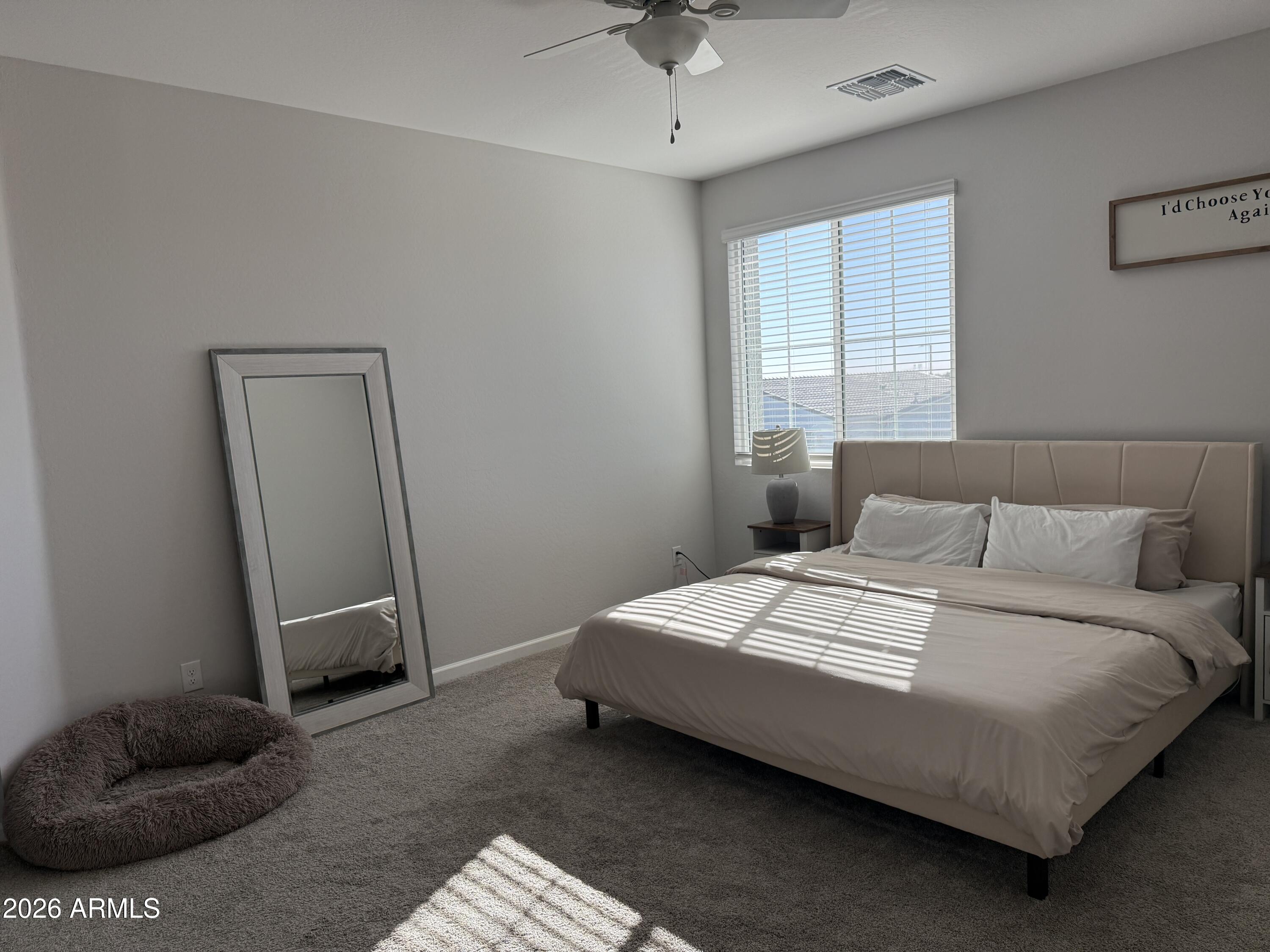 18140 West Daley Lane Surprise, AZ 85387 - Photo 13 of 23 a bedroom with a bed and a window
