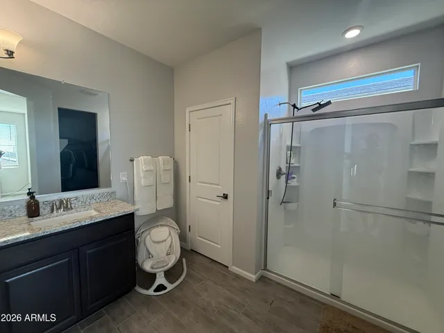 a bathroom with a toilet a sink and shower