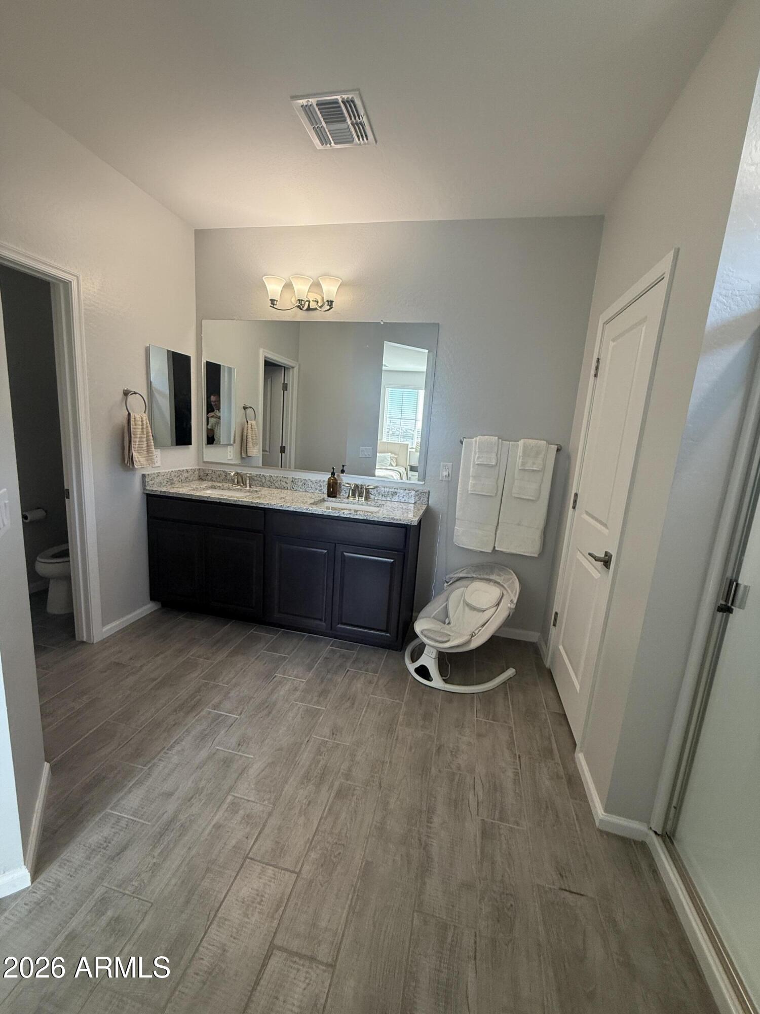18140 West Daley Lane Surprise, AZ 85387 - Photo 16 of 23 a room with furniture and wooden floor