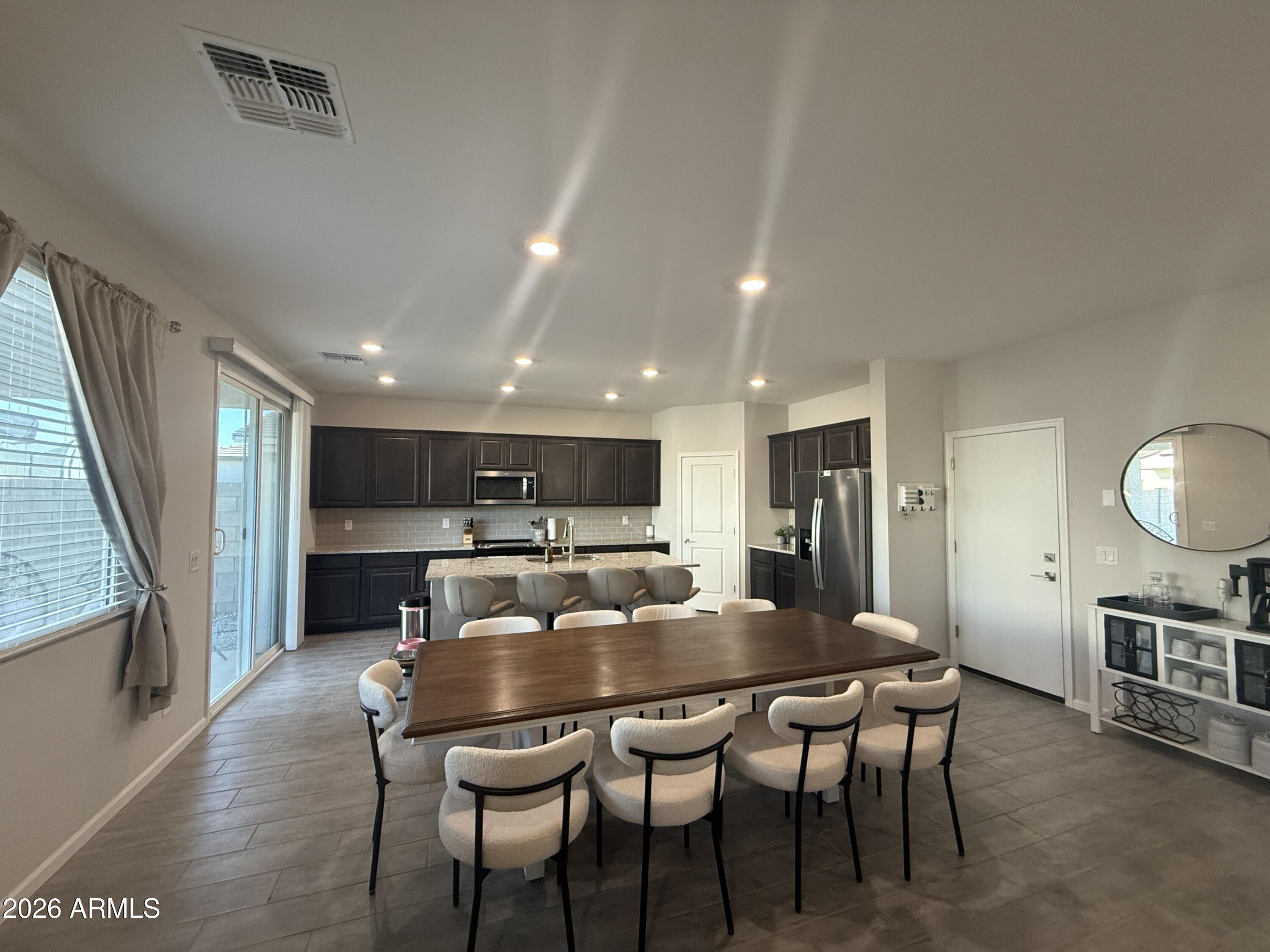 18140 West Daley Lane Surprise, AZ 85387 - Photo 3 of 23 a view of a dining room with furniture