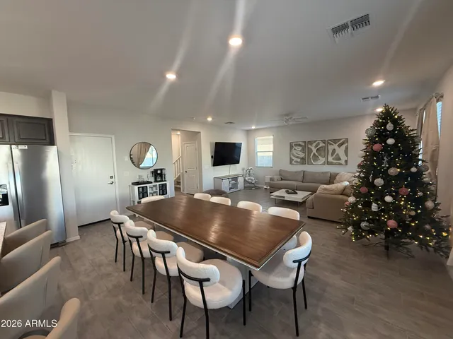 a living room with furniture a window and a flat screen tv