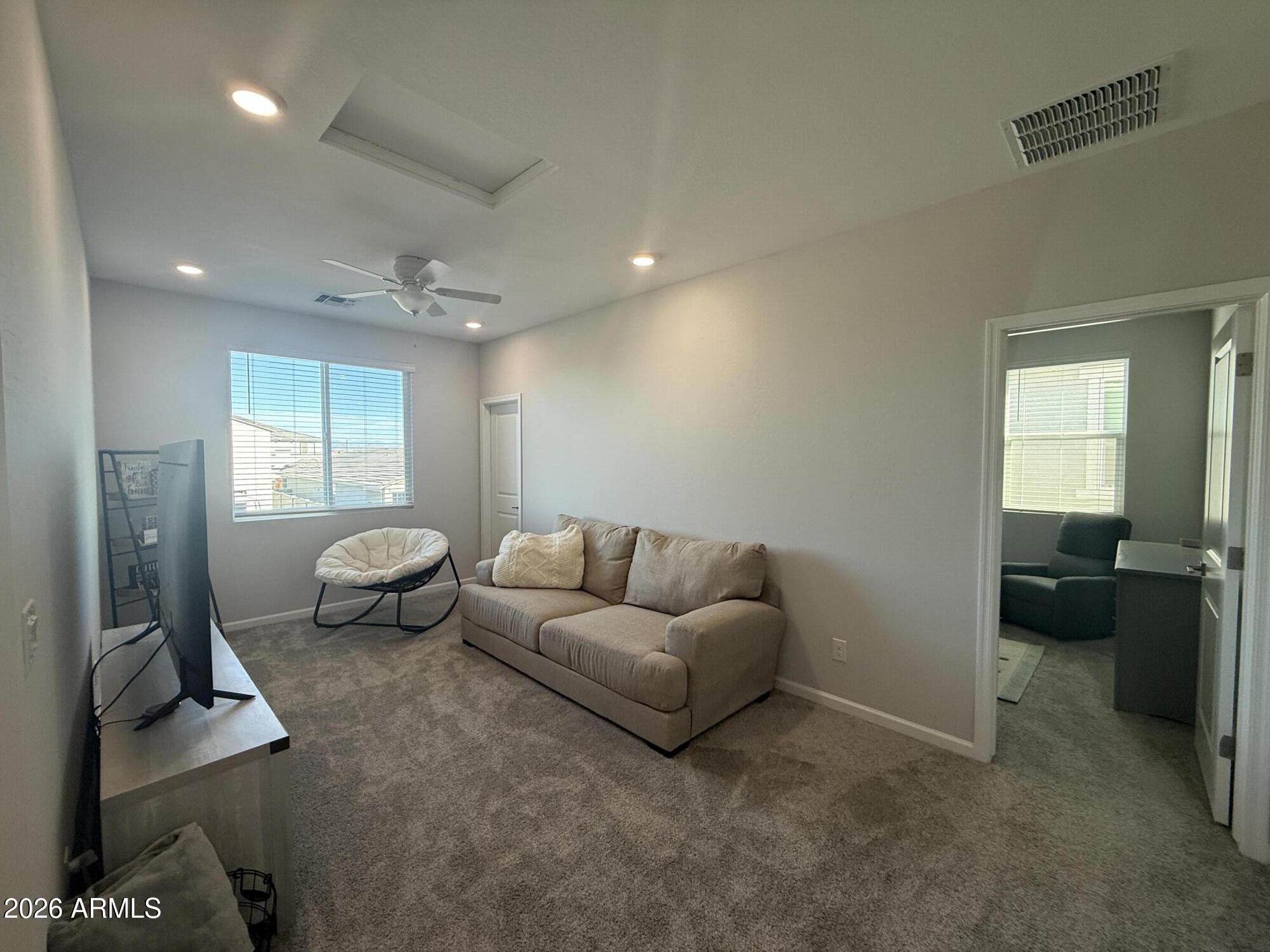 18140 West Daley Lane Surprise, AZ 85387 - Photo 7 of 23 a living room with furniture and a window