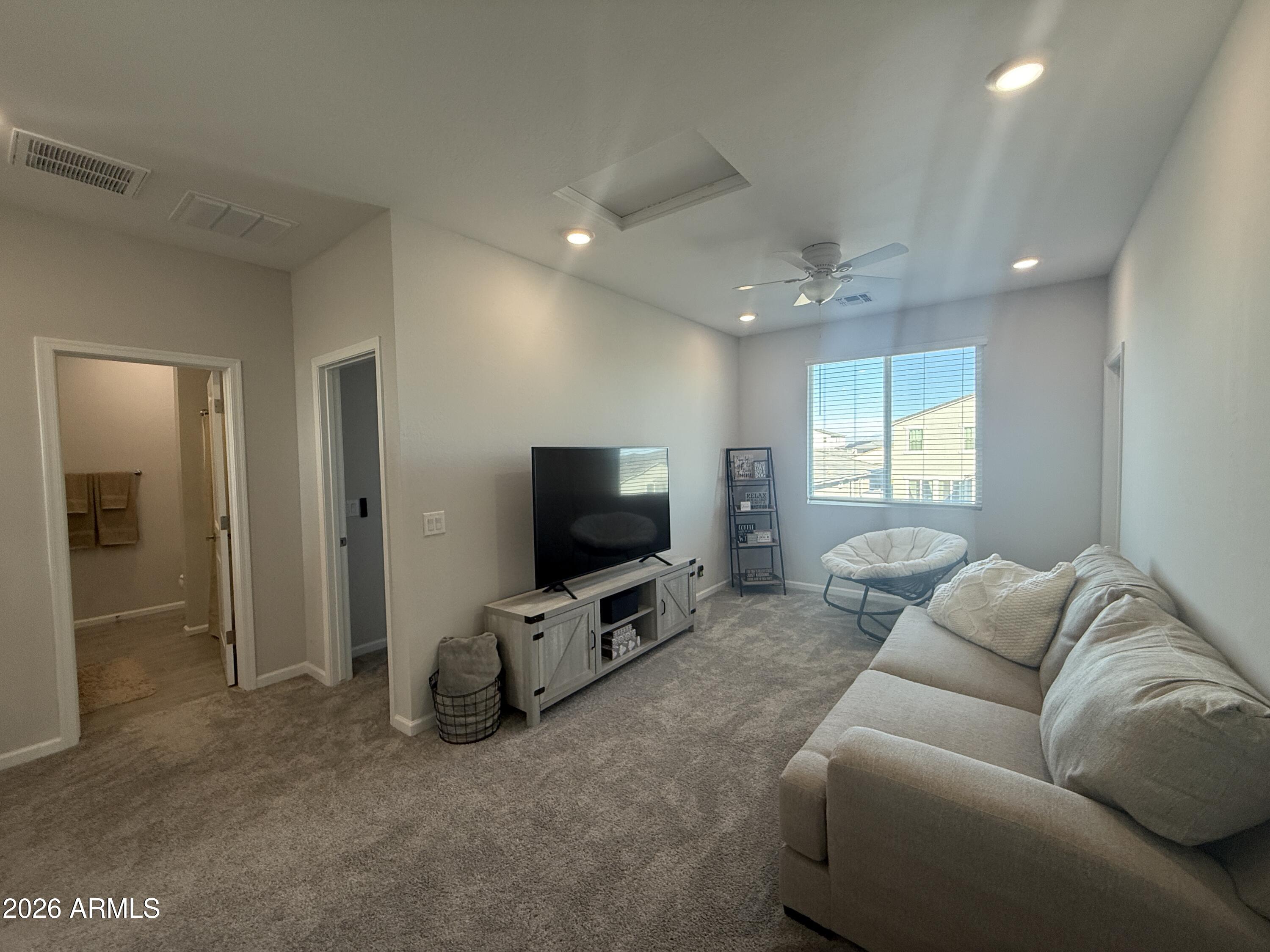 18140 West Daley Lane Surprise, AZ 85387 - Photo 8 of 23 a living room with furniture and a flat screen tv