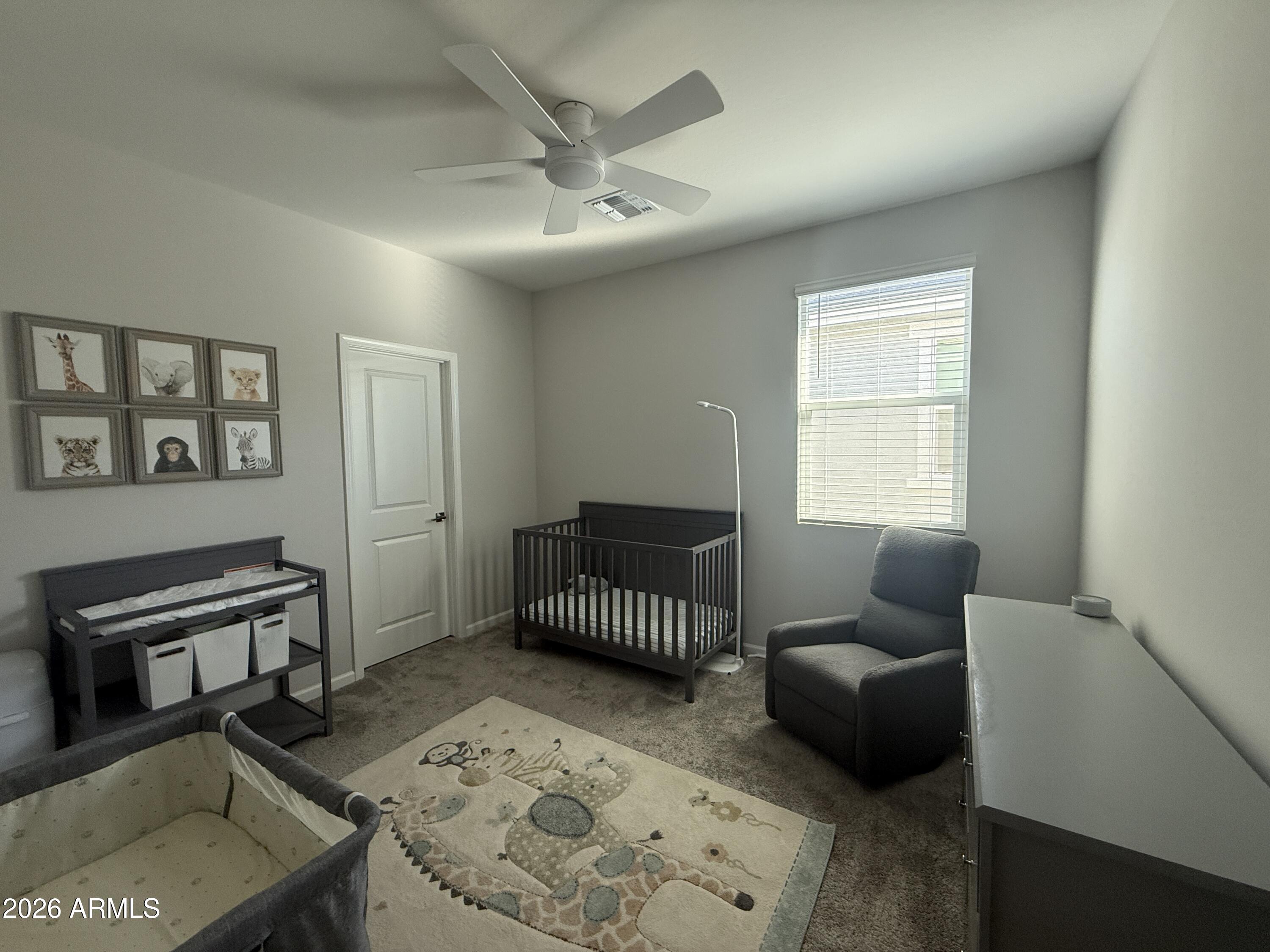 18140 West Daley Lane Surprise, AZ 85387 - Photo 9 of 23 a bedroom with furniture and a window