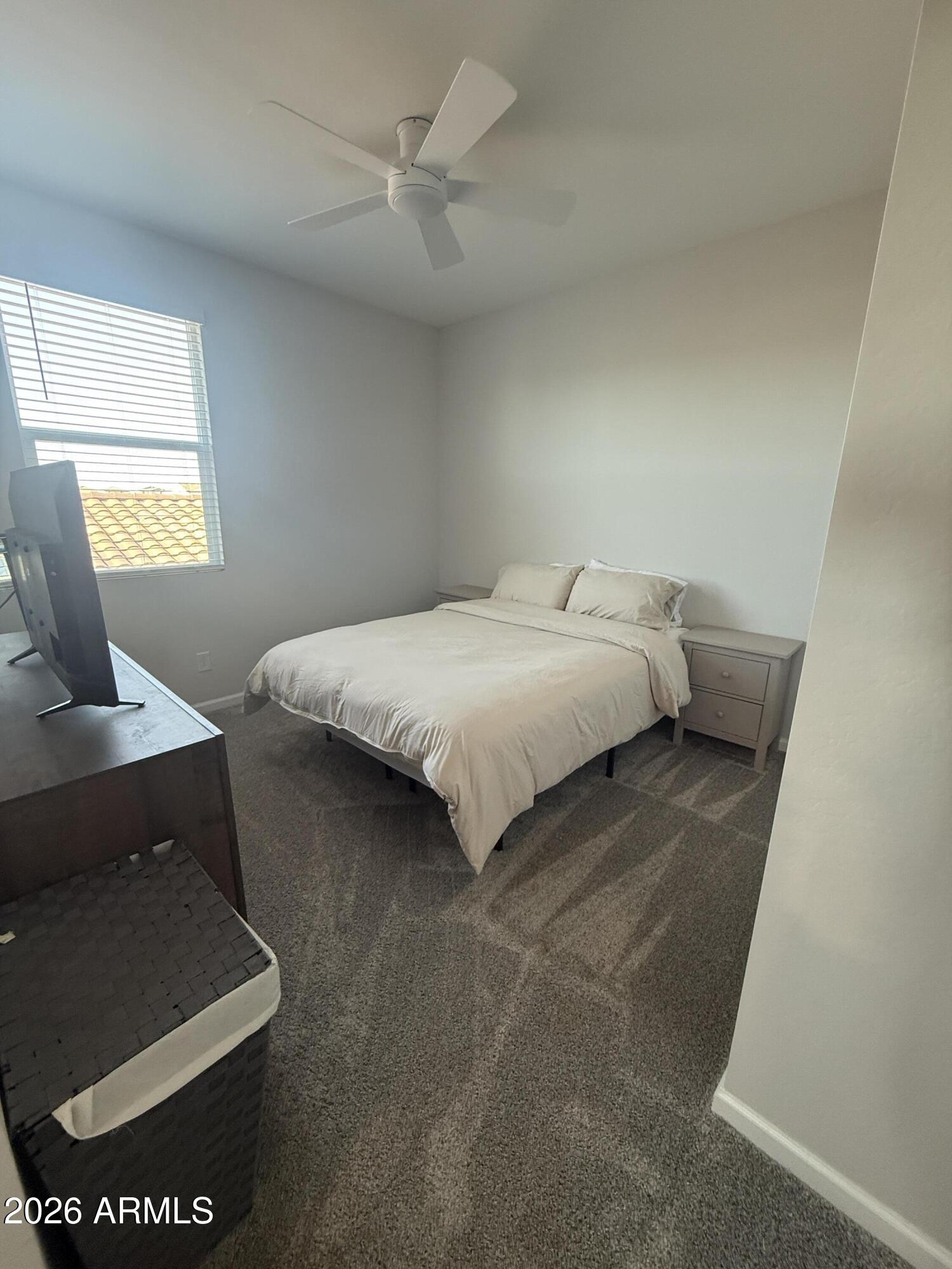 18140 West Daley Lane Surprise, AZ 85387 - Photo 10 of 23 a bedroom with a bed and window