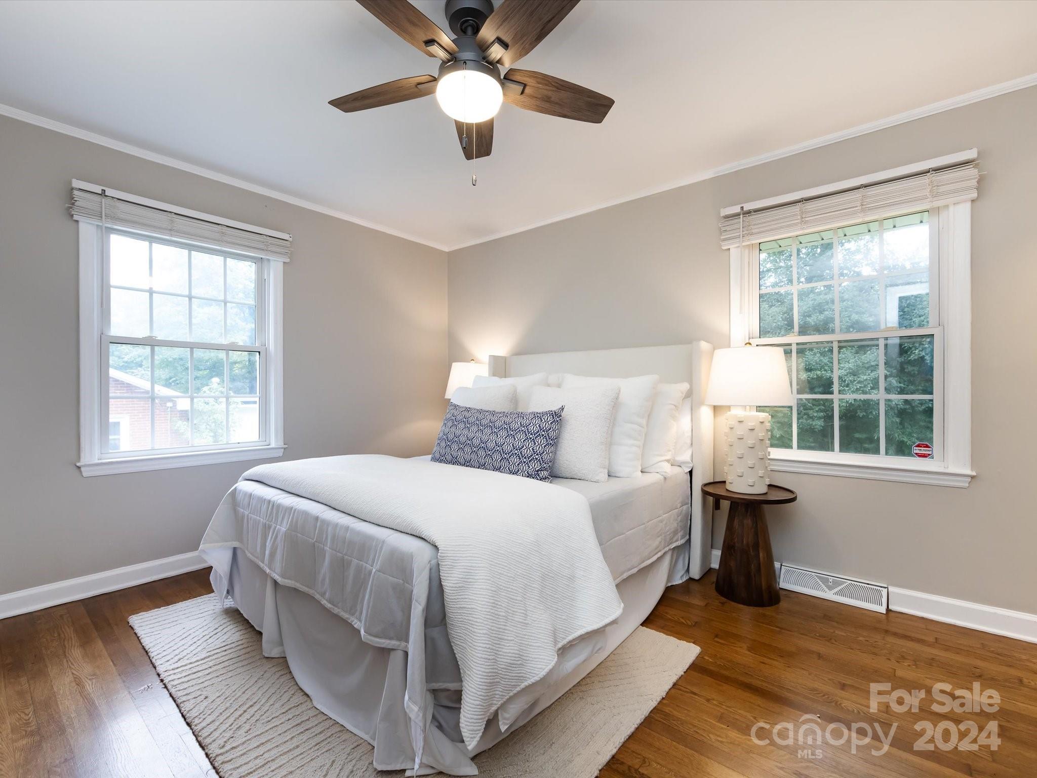 3133 Spring Valley Road Charlotte, NC 28210 - Photo 14 of 25 a bedroom with a large bed chandelier and a window